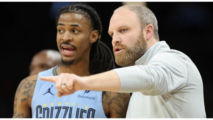 Head coach Taylor Jenkins (R) of the Memphis Grizzlies talks with Ja Morant #12 during the second half of the NBA game at Footprint Center on February 11, 2025 in Phoenix, Arizona.