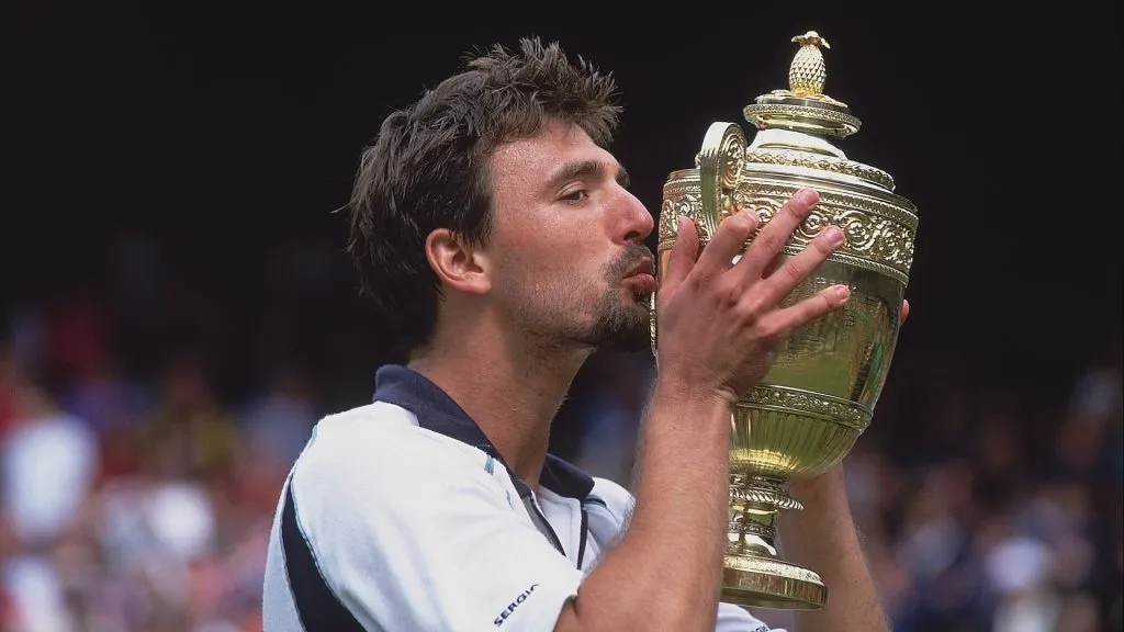 Goran Ivanisevic of Croatia kisses the winning trophy after winning the menâs final of the Wimbledon Lawn Tennis Championship.