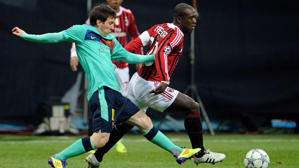Clarence Seedorf and Lionel Messi compete for the ball during the UEFA Champions League group H match between AC Milan and FC Barcelona. (Claudio Villa/Getty Images)