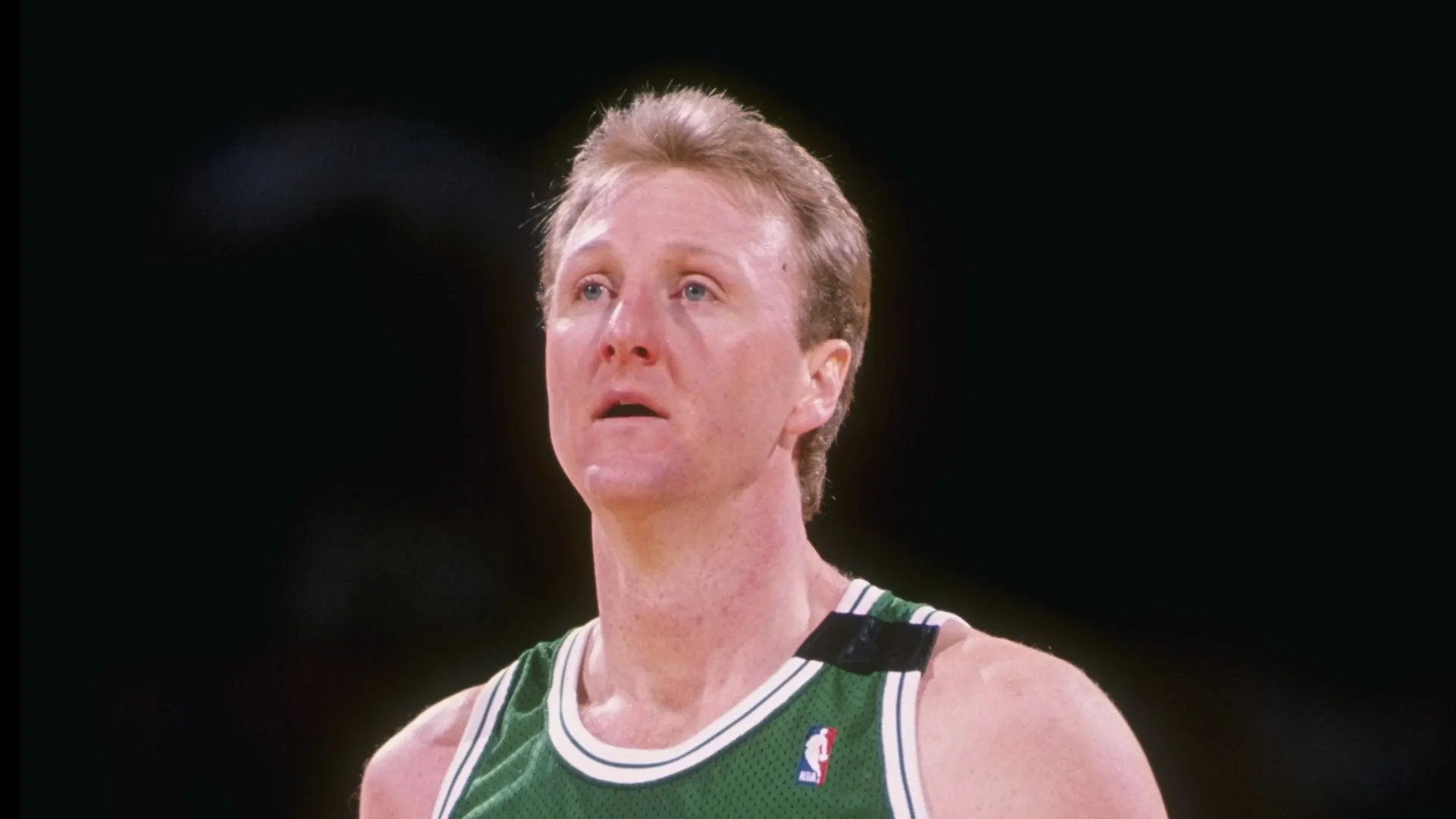 Forward Larry Bird of the Boston Celtics stands on the court during a game.