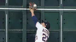 Jose Altuve #27 of the Houston Astros attempts to catch a ball hit by Juan Soto #22 of the New York Mets (not pictured) at the left field wall in the first inning at Daikin Park on March 29, 2025 in Houston, Texas.