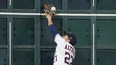 Jose Altuve #27 of the Houston Astros attempts to catch a ball hit by Juan Soto #22 of the New York Mets (not pictured) at the left field wall in the first inning at Daikin Park on March 29, 2025 in Houston, Texas.