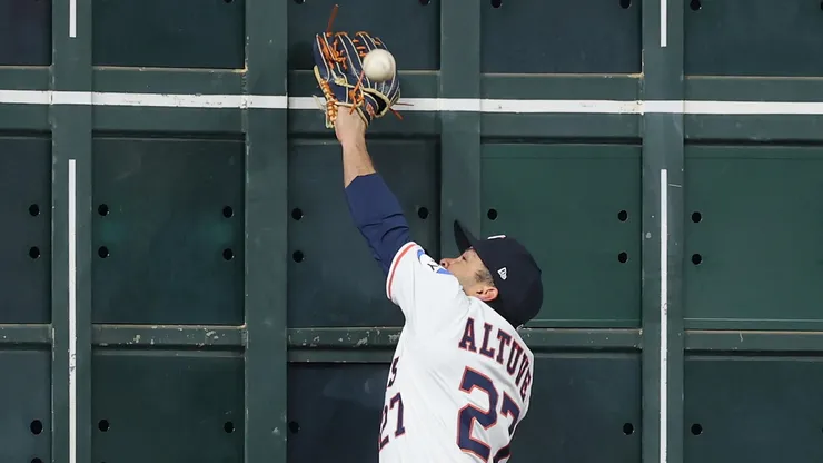 Jose Altuve #27 of the Houston Astros attempts to catch a ball hit by Juan Soto #22 of the New York Mets (not pictured) at the left field wall in the first inning at Daikin Park on March 29, 2025 in Houston, Texas.