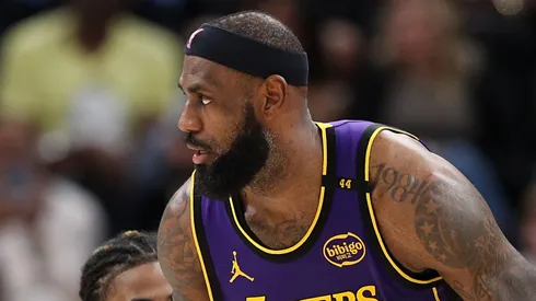 LeBron James #23 of the Los Angeles Lakers handles the ball against Ja Morant #12 of the Memphis Grizzlies during the second half at FedExForum on March 29, 2025 in Memphis, Tennessee.