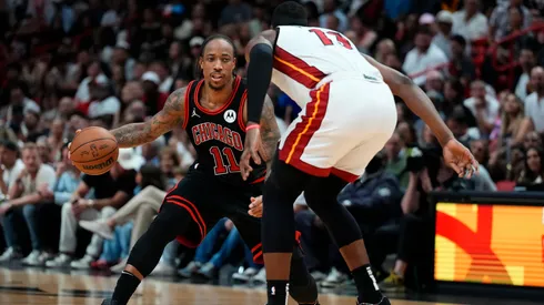 DeMar DeRozan #11 of the Chicago Bulls dribbles the ball against Bam Adebayo #13 of the Miami Heat in the fourth quarter during the Play-In Tournament in 2024.