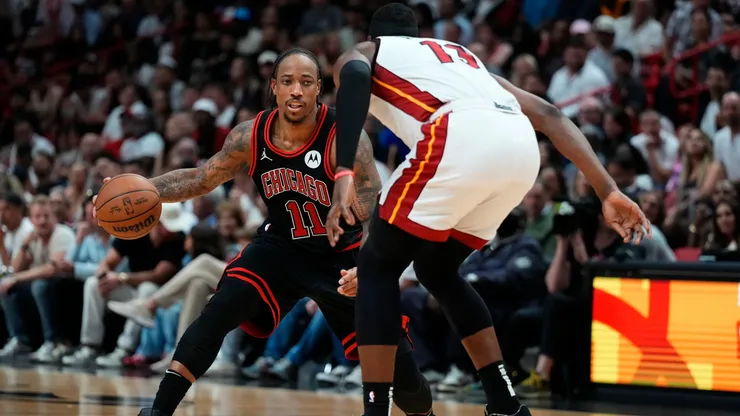 DeMar DeRozan #11 of the Chicago Bulls dribbles the ball against Bam Adebayo #13 of the Miami Heat in the fourth quarter during the Play-In Tournament in 2024.