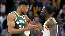 Draymond Green #23 of the Golden State Warriors and Giannis Antetokounmpo #34 of the Milwaukee Bucks slap hands after the Warriors defeated the Bucks.
