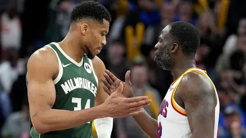 Draymond Green #23 of the Golden State Warriors and Giannis Antetokounmpo #34 of the Milwaukee Bucks slap hands after the Warriors defeated the Bucks.