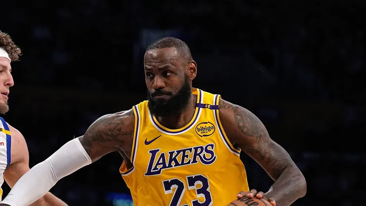 LeBron James #23 of the Los Angeles Lakers dribbles the ball during the first half of a game against Brandin Podziemski #2 of the Golden State Warriors