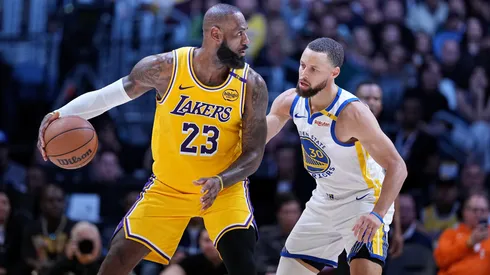 Los Angeles Lakers star LeBron James dribbling against Stephen Curry.