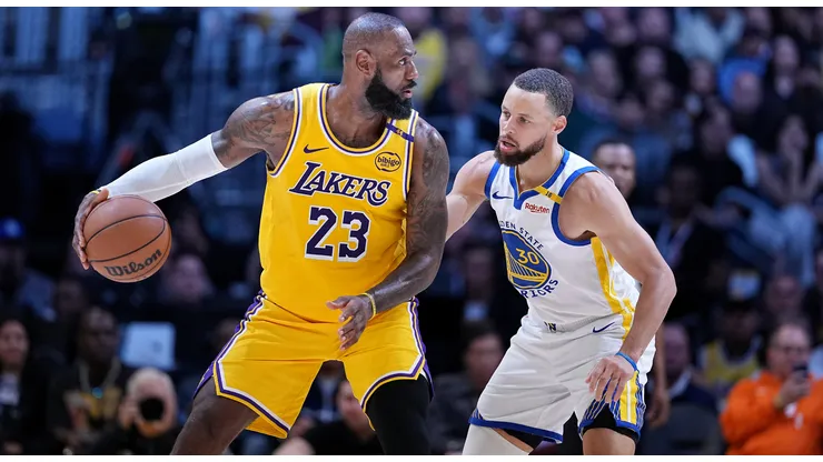 Los Angeles Lakers star LeBron James dribbling against Stephen Curry.