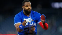 Vladimir Guerrero Jr. #27 of the Toronto Blue Jays reacts after sliding safely into third base as he advances on a pop-fly from teammate Andrés Giménez #0 in the first inning of their MLB game against the Baltimore Orioles at Rogers Centre on March 29, 2025 in Toronto, Ontario, Canada.