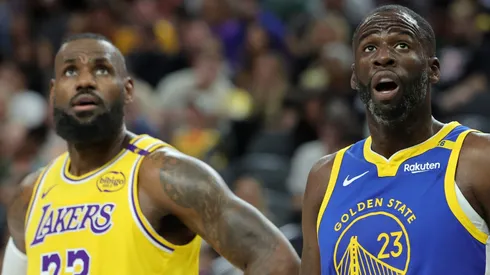 LeBron James #23 of the Los Angeles Lakers and Draymond Green #23 of the Golden State Warriors watch as a Warriors player shoots a free throw.