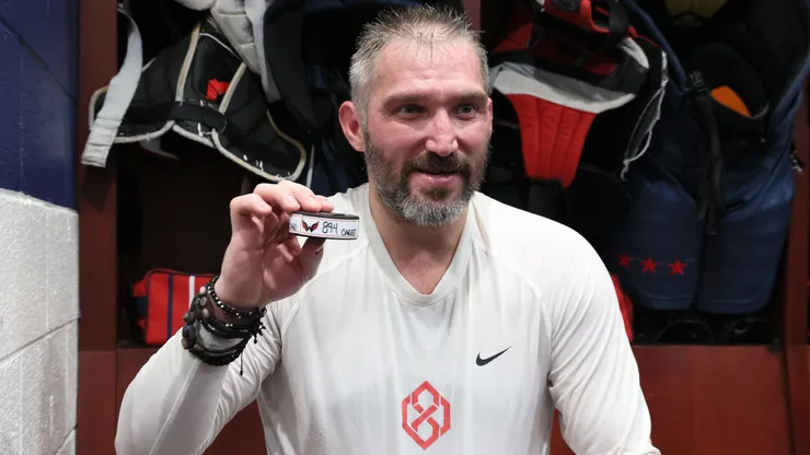 Alex Ovechkin #8 of the Washington Capitals holds the puck from his 894th career goal scored in the locker room after defeating the Chicago Blackhawks at Capital One Arena on April 04, 2025 in Washington, DC. Ovechkin's goal ties him with Wayne Gretzky for the all-time goal scoring record.