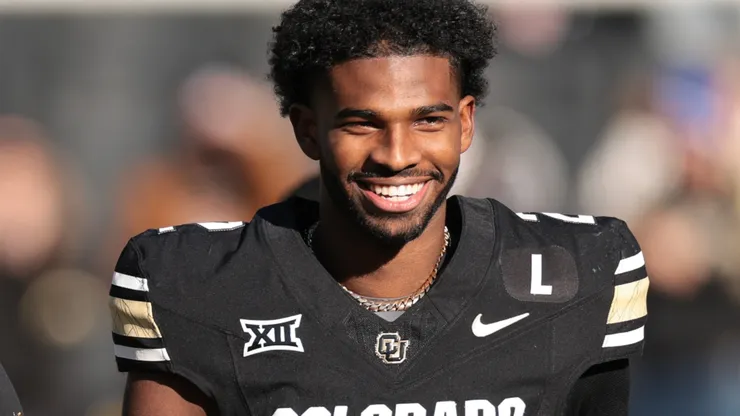 (L-R) Shilo Sanders #21, Head coach Deion Sanders and Shedeur Sanders #2 of the Colorado Buffaloes walk the field during senior day celebrations prior to the game against the Oklahoma State Cowboys at Folsom Field on November 29, 2024 in Boulder, Colorado.