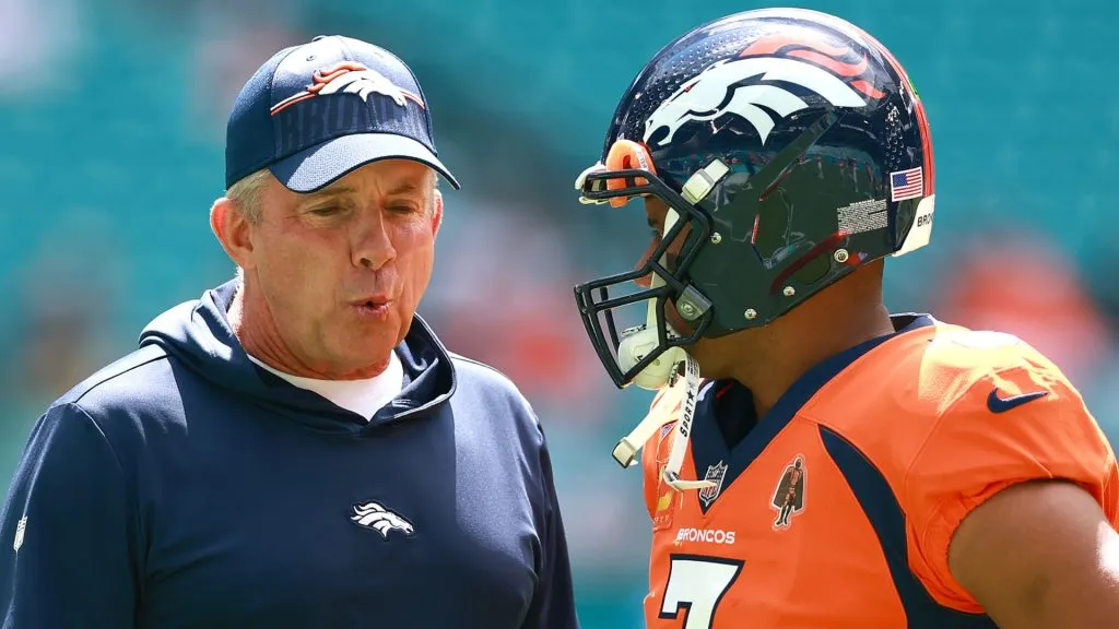 Head coach Sean Payton of the Denver Broncos talks to Russell Wilson prior to a game against the Miami Dolphins at Hard Rock Stadium on September 24, 2023 in Miami Gardens, Florida.