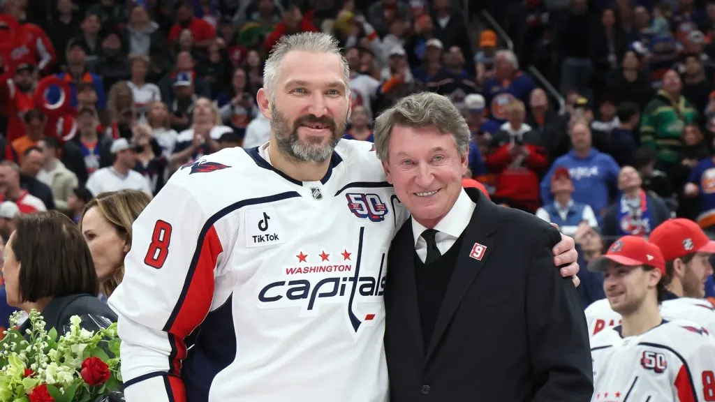Alex Ovechkin #8 of the Washington Capitals poses with former NHL player Wayne Gretzky after scoring his 895th career goal during the second period against the New York Islanders at UBS Arena on April 06, 2025 in Elmont, New York. Ovechkin’s goal passes Gretzky’s 894 goals to become the NHL all-time goal-scoring leader.