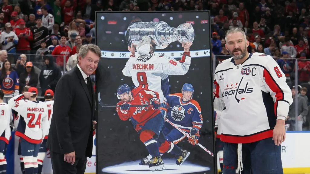 Alex Ovechkin #8 of the Washington Capitals poses with former NHL player Wayne Gretzky after scoring his 895th career goal during the second period against the New York Islanders at UBS Arena on April 06, 2025 in Elmont, New York. Ovechkin’s goal passes Gretzky’s 894 goals to become the NHL all-time goal-scoring leader.