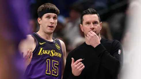 Austin Reaves #15 of the Los Angeles Lakers and head coach JJ Redick talk during the second quarter against the Dallas Mavericks at American Airlines Center on January 07, 2025 in Dallas, Texas.
