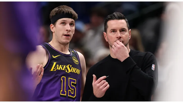 Austin Reaves #15 of the Los Angeles Lakers and head coach JJ Redick talk during the second quarter against the Dallas Mavericks at American Airlines Center on January 07, 2025 in Dallas, Texas.