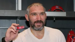 Alex Ovechkin #8 of the Washington Capitals poses with the puck used during his 895th career goal in the second period against the New York Islanders at UBS Arena on April 06, 2025 in Elmont, New York. Ovechkin's goal passes Wayne Gretzky's 894 goals to become the NHL all-time goal-scoring leader.