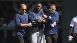 Victor Robles #10 of the Seattle Mariners is helped off the field after hurting himself while catching a foul fly ball and running into the wall flipping over the fence into the netting against the San Francisco Giants in the bottom of the ninth inning at Oracle Park on April 06, 2025 in San Francisco, California.