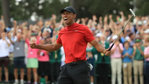 Tiger Woods (L) of the United States celebrates on the 18th green after winning the Masters at Augusta National Golf Club on April 14, 2019.