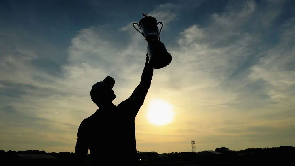 Brooks Koepka of the United States celebrates with the U.S. Open Championship trophy after winning the 2018 U.S. Open at Shinnecock Hills Golf Club on June 17, 2018. (Source: Andrew Redington/Getty Images)