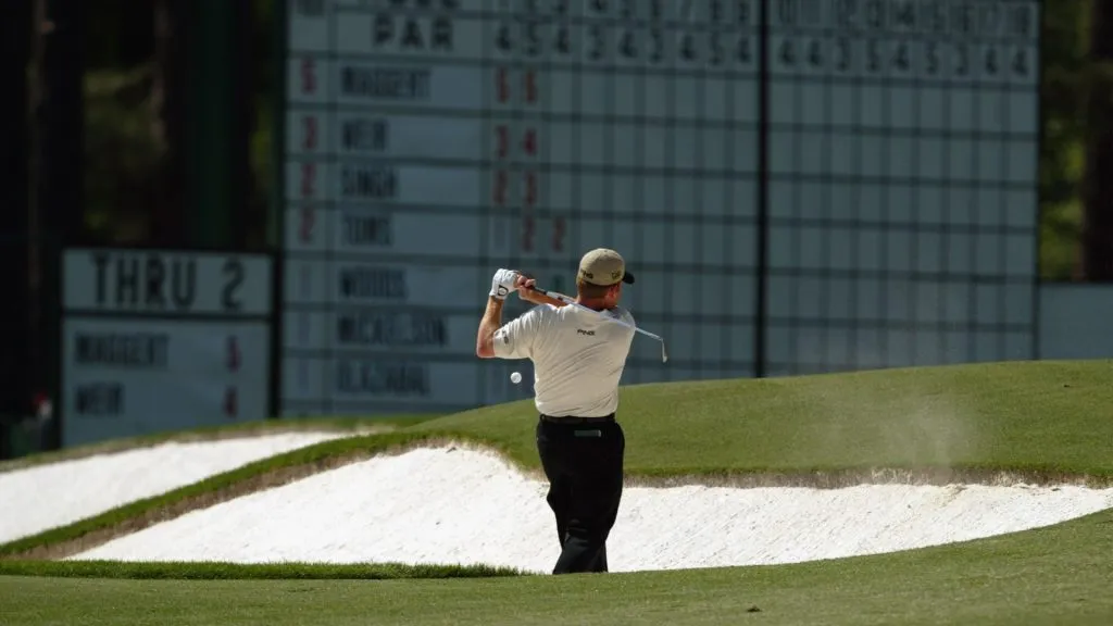 Jeff Maggert of the USA plays out of the third hole bunker as the ball comes back and hits him during the final round of the 2003 Masters Tournament. (Source: Getty Images)