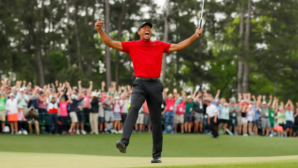 Tiger Woods of the United States celebrates after sinking his putt on the 18th green to win during the final round of the Masters at Augusta National Golf Club on April 14, 2019. (Source: Kevin C. Cox/Getty Images)