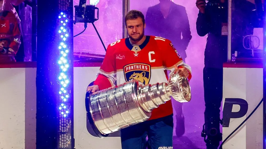 Aleksander Barkov #16 of the Florida Panthers carries the Stanley Cup Trophy onto the ice prior to the game against the Boston Bruins at the Amerant Bank Arena on October 8, 2024 in Sunrise, Florida.