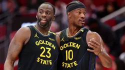 Draymond Green #23 and Jimmy Butler #10 of the Golden State Warriors speak on the court against the Houston Rockets during the first half at Toyota Center on February 13, 2025 in Houston, Texas.