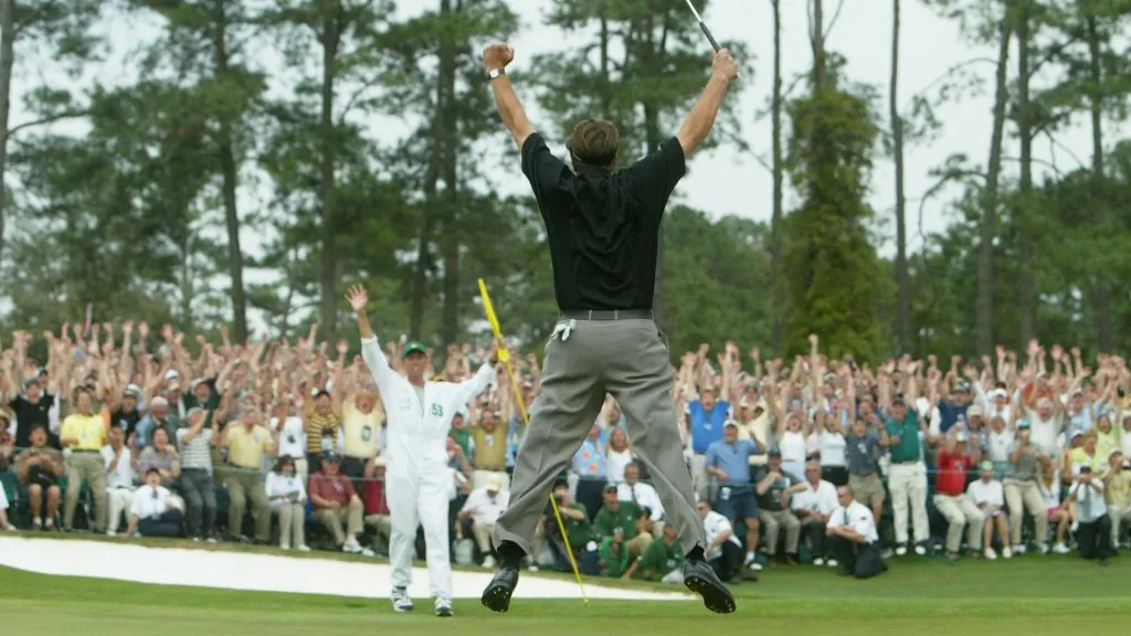 Phil Mickelson jumps in the air after sinking his birdie putt to win the Masters by one shot on the 18th green during the final round of the Masters on April 11, 2004. (Source: Andrew Redington/Getty Images)