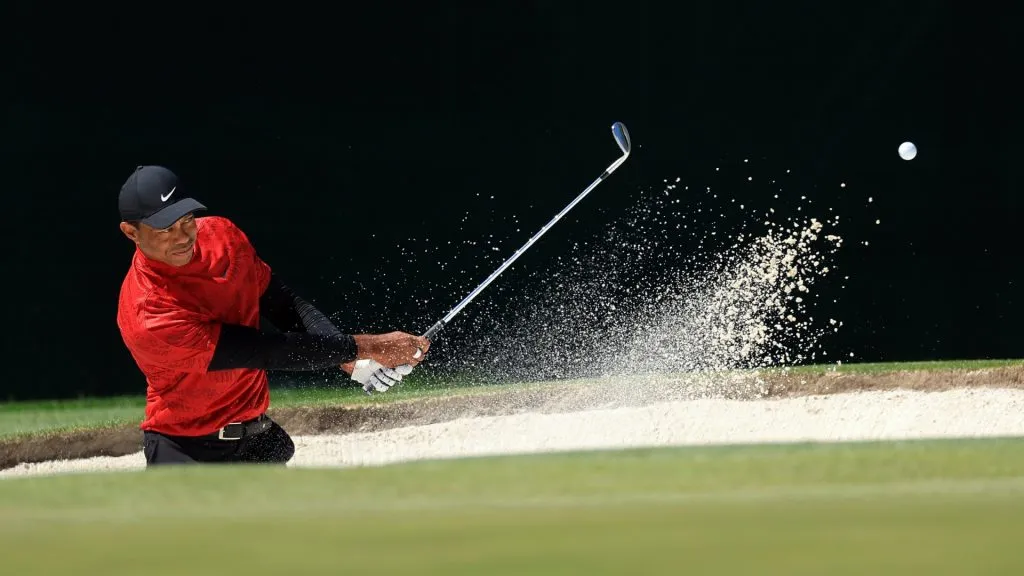 Tiger Woods plays his shot from the bunker on the fourth hole during the final round of the Masters at Augusta National Golf Club on April 10, 2022. (Source: David Cannon/Getty Images)