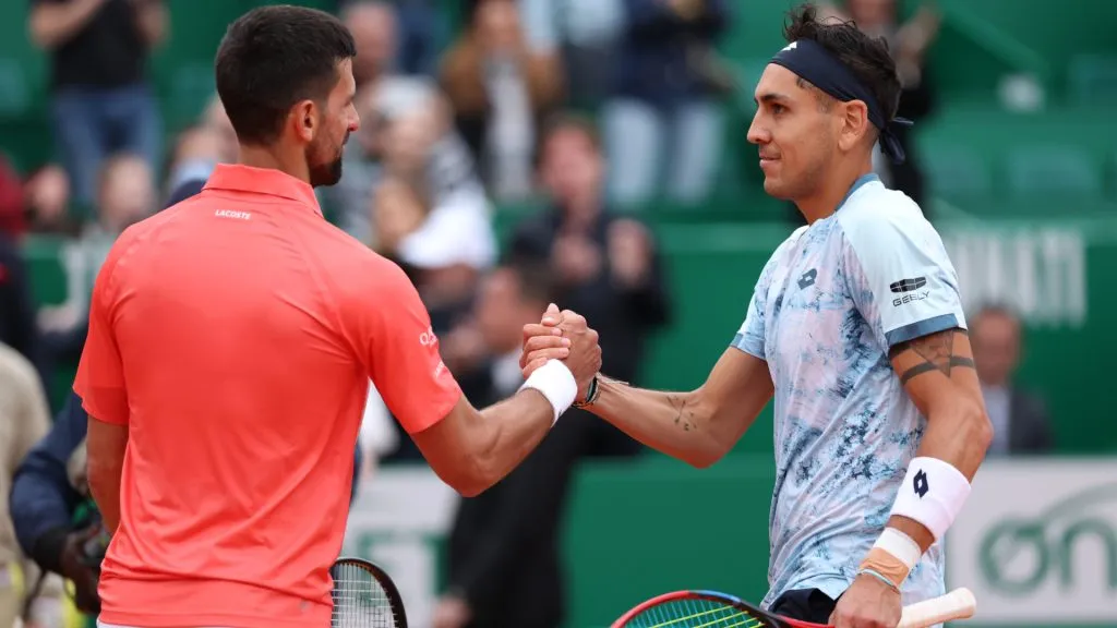 Alejandro Tabilo shakes hands with Novak Djokovic at the net after his victory in the Monte-Carlo Masters. (Clive Brunskill/Getty Images)