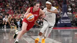 Caitlin Clark #22 of the Indiana Fever dribbles the ball while being guarded by Sydney Colson #51 of the Las Vegas Aces in the first quarter at Gainbridge Fieldhouse on September 11, 2024.