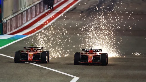 Sparks fly from the cars of Carlos Sainz driving the Ferrari SF-24 and Charles Leclerc driving the Ferrari SF-24 as they compete for track position during the F1 Grand Prix of Bahrain in 2024.