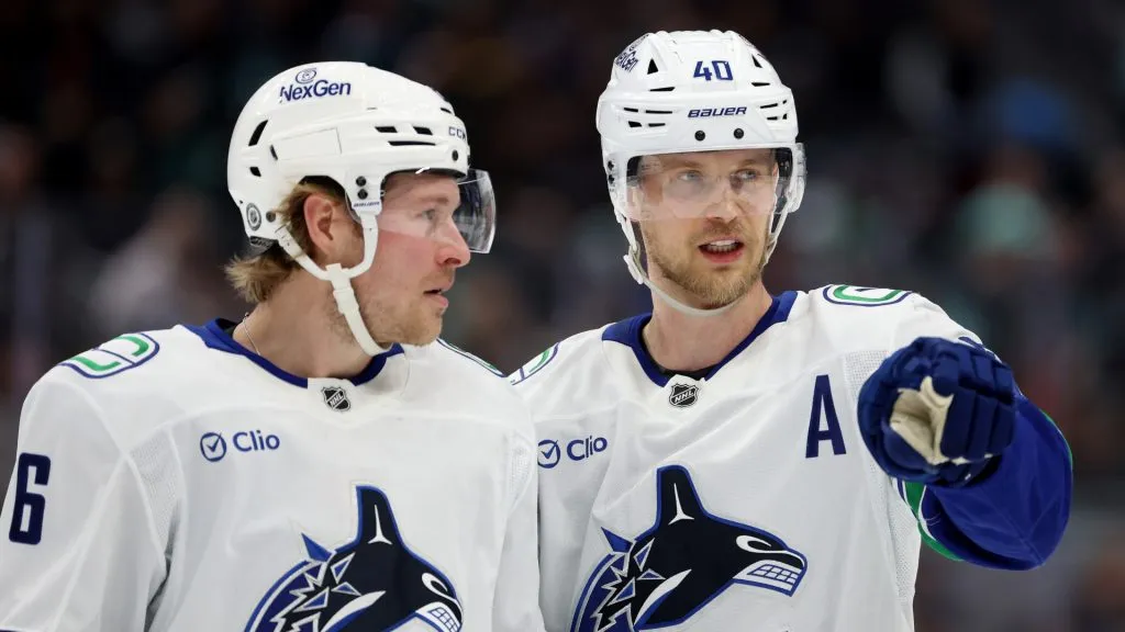 Brock Boeser #6 and Elias Pettersson #40 of the Vancouver Canucks talk during the first period against the Seattle Kraken at Climate Pledge Arena on March 01, 2025 in Seattle, Washington.