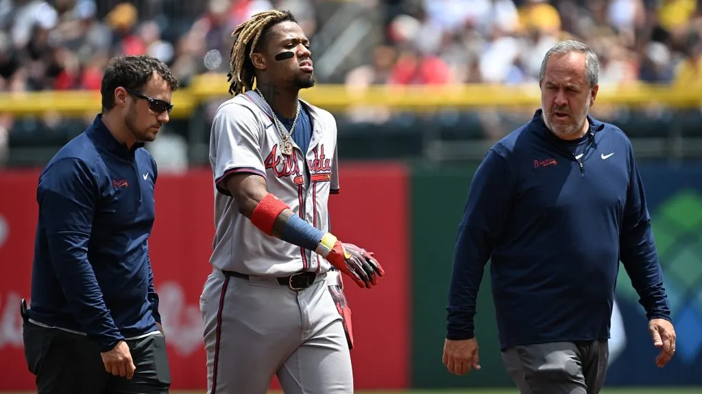 Ronald Acuña Jr. #13 of the Atlanta Braves walks off the field with trainers after an apparent injury in the first inning during the game against the Pittsburgh Pirates at PNC Park on May 26, 2024 in Pittsburgh, Pennsylvania. (Photo by Justin Berl/Getty Images)