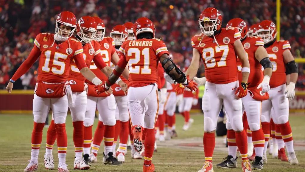 Mike Edwards #21 of the Kansas City Chiefs greets Patrick Mahomes and Travis Kelce as he takes the field before the AFC Wild Card Playoffs against the Miami Dolphins at GEHA Field at Arrowhead Stadium on January 13, 2024 in Kansas City, Missouri.