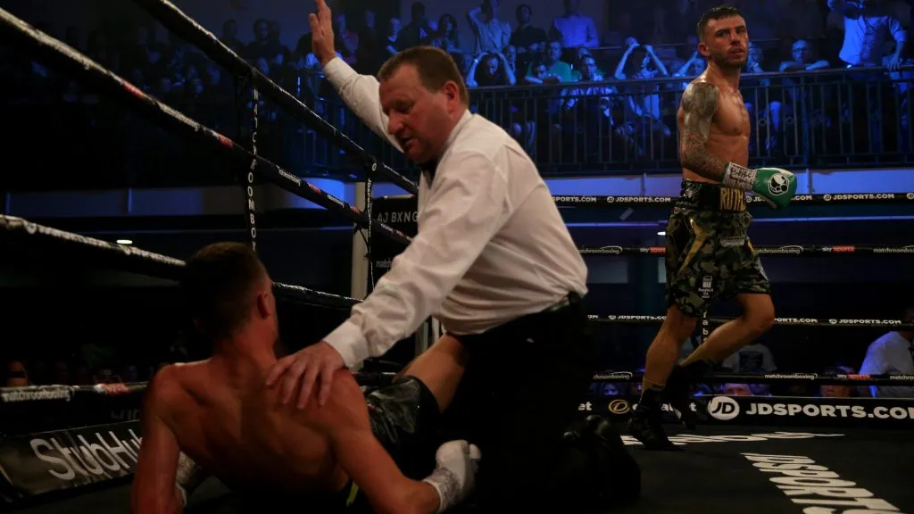 Ryan Doyle runs to the corner as the referee checks on Reece Belloti after being knocked down during the Commonwealth Featherweight Championship contest between Reece Bellotti and Ryan Doyle in 2018. (Source: James Chance/Getty Images)