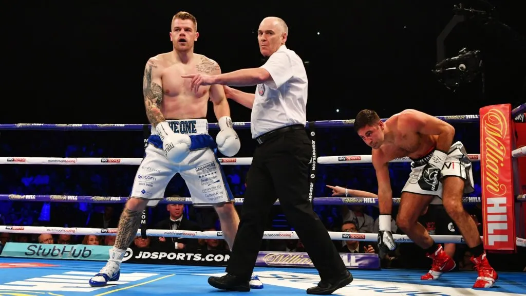 Callum Johnson is ushered to a neutral corner by referee Victor Loughlin as he knocks down Frank Buglioni during their British and Commonwealth Light-Heavyweight Championship in 2018. (Source: Dan Mullan/Getty Images)
