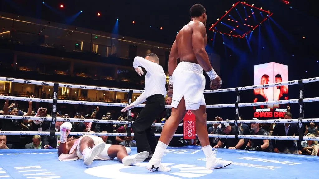 Francis Ngannou is knocked down for the third time as Referee Ricky Gonzalez stops the fight during the Heavyweight fight between Anthony Joshua and Francis Ngannou on the Knockout Chaos boxing card in 2024. (Source: Richard Pelham/Getty Images)