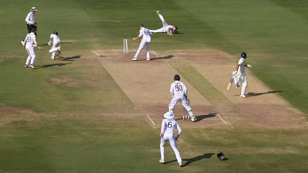 England captain Ben Stokes throws the ball to run out India batsman Ravindra Jadeja as bowler Joe Root looks on during day four of the 1st Test Match between India and England in 2024. (Source: Stu Forster/Getty Images)