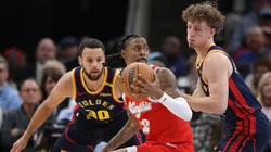 Ja Morant #12 of the Memphis Grizzlies handles the ball against Brandin Podziemski #2 of the Golden State Warriors during the first half at FedExForum on December 19, 2024 in Memphis, Tennessee.