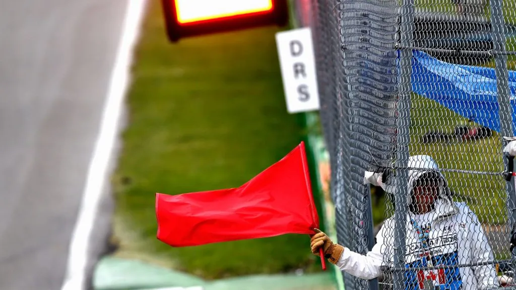 A marshal waves a red flag at the end of the session during final practice ahead of the Canadian Formula One Grand Prix at Circuit Gilles Villeneuve on June 11, 2016. (Source: Charles Coates/Getty Images)