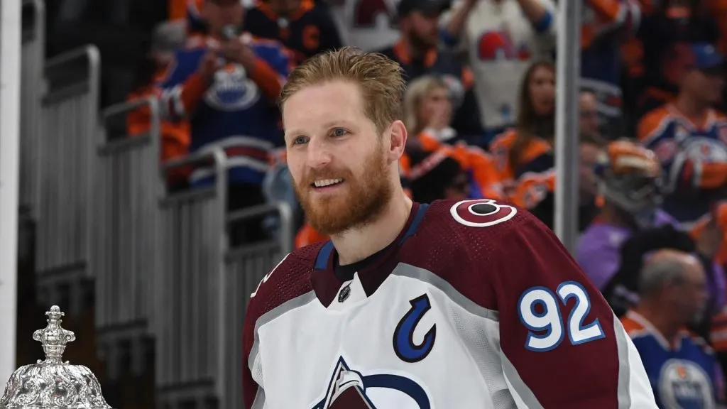 Gabriel Landeskog #92 of the Colorado Avalanche poses for a photo with Deputy Commissioner Bill Daly before the presentation of the Clarence S. Campbell Bowl after defeating the Edmonton Oilers 6-5 in overtime in Game Four of the Western Conference Final of the 2022 Stanley Cup Playoffs at Rogers Place on June 06, 2022 in Edmonton, Alberta.
