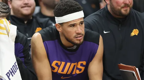 Devin Booker #1 of the Phoenix Suns reacts on the bench during the final moments of the NBA game against the San Antonio Spurs at PHX Arena on April 11, 2025 in Phoenix, Arizona.