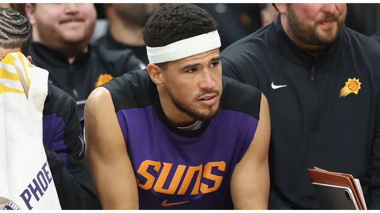 Devin Booker #1 of the Phoenix Suns reacts on the bench during the final moments of the NBA game against the San Antonio Spurs at PHX Arena on April 11, 2025 in Phoenix, Arizona.