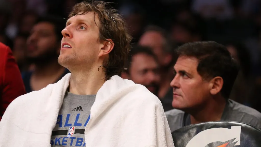 Dirk Nowitzki #41 of the Dallas Mavericks sits on the bench in front of owner Mark Cuban during the game with the Los Angeles Lakers at Staples Center. (Stephen Dunn/Getty Images)